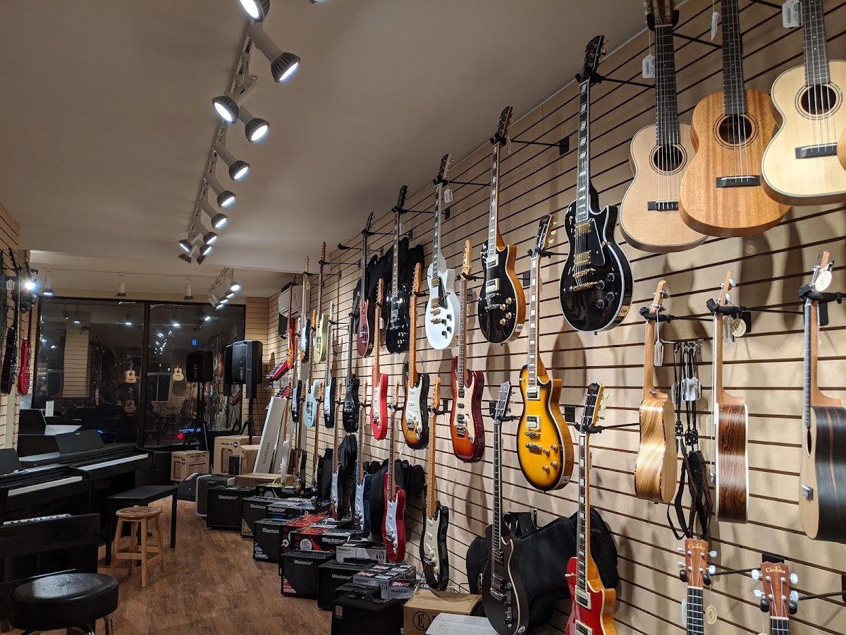 Guitar wall at École de musique du Marché — electric and acoustic guitars on display